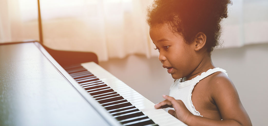 children girl playing piano looking exciting happy and enjoy with music instrument and be player