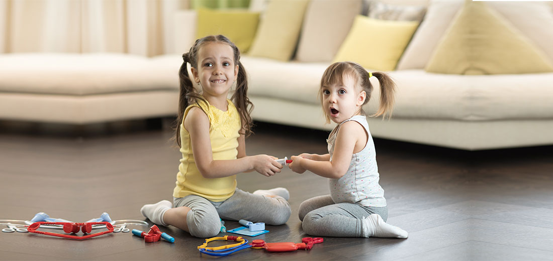 Conflict between little sisters. Kids are fighting, toddler girl takes toy, sibling relationships